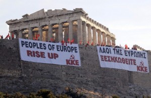 A banner from the Communist Party of Greece hangs near the Parthenon on Acropolis hill in Athens, Greece on 04 May 2010. They had staged a takeover of the Acropolis at dawn in protest of the government's austerity measures. (Photo: EPA / Panagiotis Moschandreou)