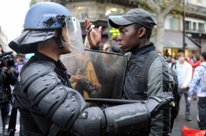 A French high school student faces riot gendarmes during a student demonstration at the Place de la Republique in Paris October 19, 2010. (Photo: REUTERS/Gonzalo Fuentes)