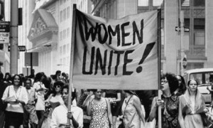 Signs saying Women Unite carried by women supporters during Women's Liberation demonstration on Fifth Avenue and on Wall Street. (Photo by John Olson//Time Life Pictures/Getty Images)
