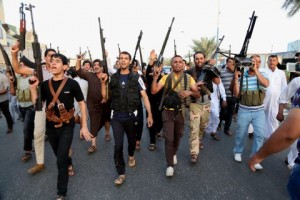 Iraqi Shiite tribal fighters deploy with their weapons while chanting slogans against the al-Qaida inspired Islamic State of Iraq and the Levant (ISIL) - AP Photo/Karim Kadim
