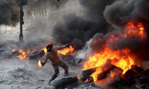 A protester throw a Molotov cocktail towards riot police during a clash in central Kyiv, Ukraine, on Jan. 25, 2014. (AP Photo/Efrem Lukatsky)