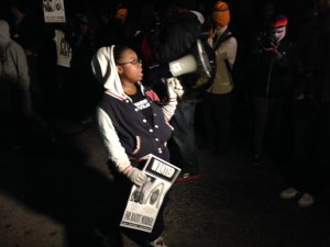 A young protester leads a chant on Canfield Road, the spot where Mike Brown was shot and killed. (Photo: Howard Koplowitz)