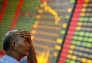  A man gestures as he watches stock activity at a stock exchange in Huaibei, China. (Photo: STR / AFP / Getty Images)