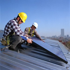 Workers install solar panels