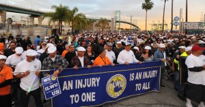 Workers gather in solidarity near the Vincent Thomas Bridge, before marching along the San Pedro waterfront on January 22, 2014. (Photo by Stephen Carr / Daily Breeze)