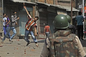 A Kashmiri Muslim protester throws stones and bricks at Indian police and paramilitary soldiers during a protest in Srinagar, India, Monday, Sept. 6, 2010.(Photo: AP Photo/Mukhtar Khan)