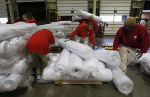 Inmates in Correctional Industries' Tumwater facility unload materials that will be used in a furniture factory. (Photo: Alan Berner / The Seattle Times)