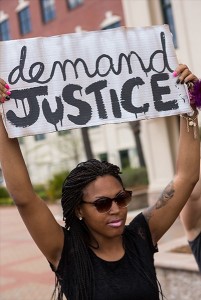 People participate in a rally to protest the death of Walter Scott, who was killed by police in a shooting, outside City Hall on April 8, 2015 in North Charleston, South Carolina (Photo: Richard Ellis / Getty Images)